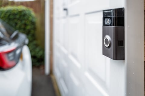 Battery powered wireless doorbell and integral camera at entrance